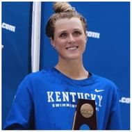 Riley gains poses with a trophy after tying with Lia Thomas for fifth place (Image via Instagram/@rileygbarker)